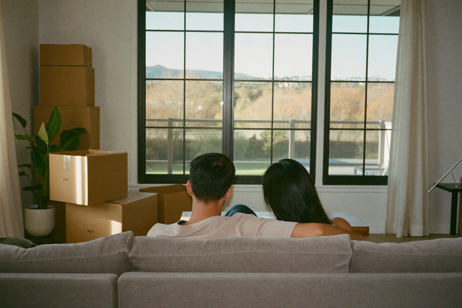A couple taking a quiet moment together in a home with moving boxes